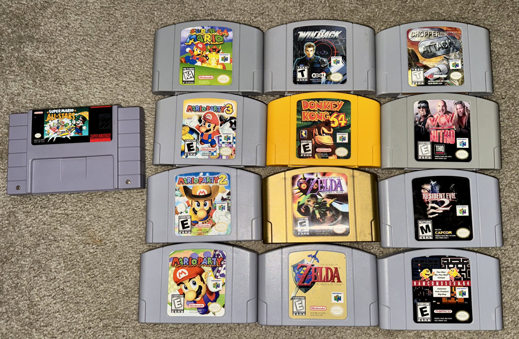 Nintendo 64 cartridges with a SNES Super Mario All-Stars, including Super Mario 64, Zelda Majora's Mask and Ocarina of Time